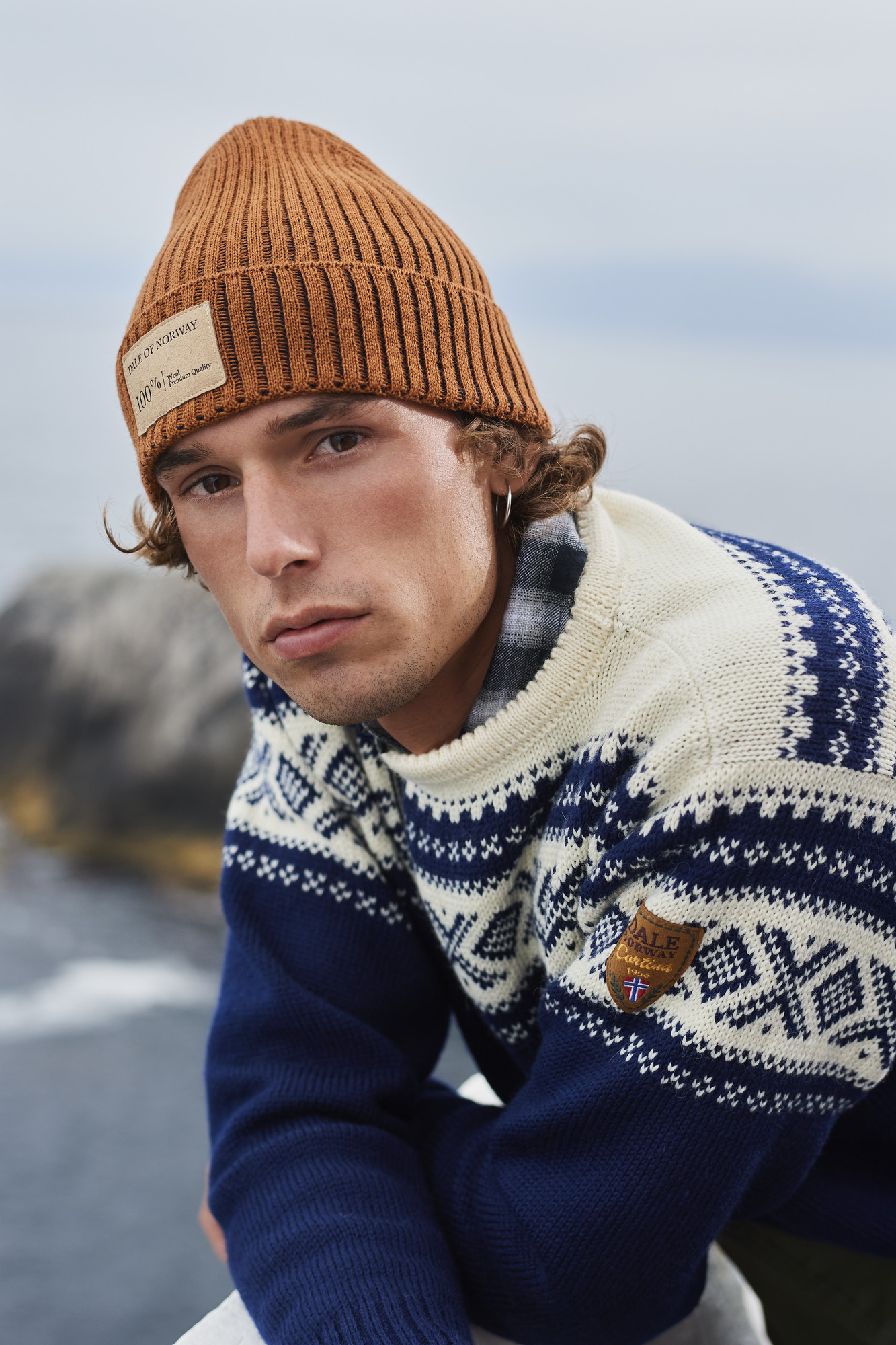 Male model wearing the blue Cortina Olympic Sweater from Dale of Norway