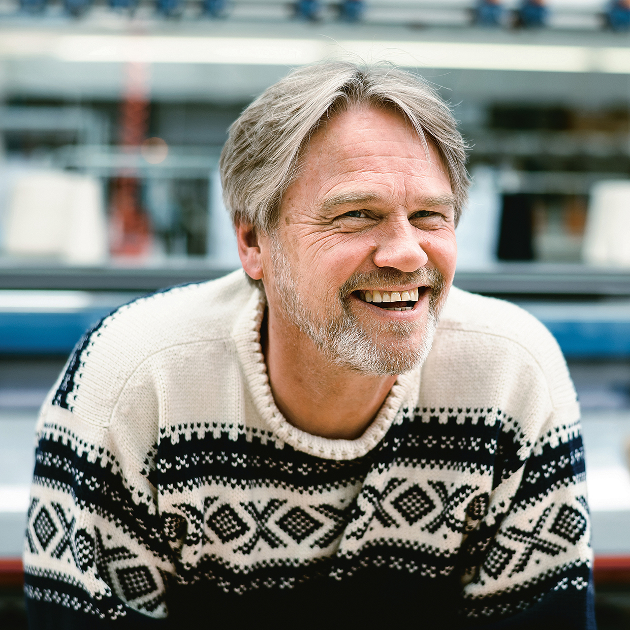 Male employee working at Dale of Norway wearing a Dale of Norway sweater